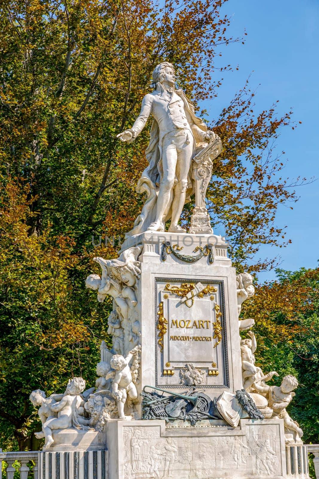 Mozart Statue with flower decoration in the form of a musical treble clef key, Vienna, Austria