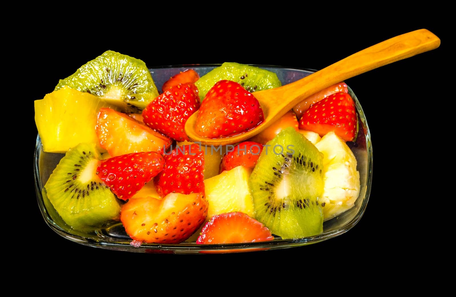 fresh fruit macedonia cut into cubes, Isolated background in black with spoon