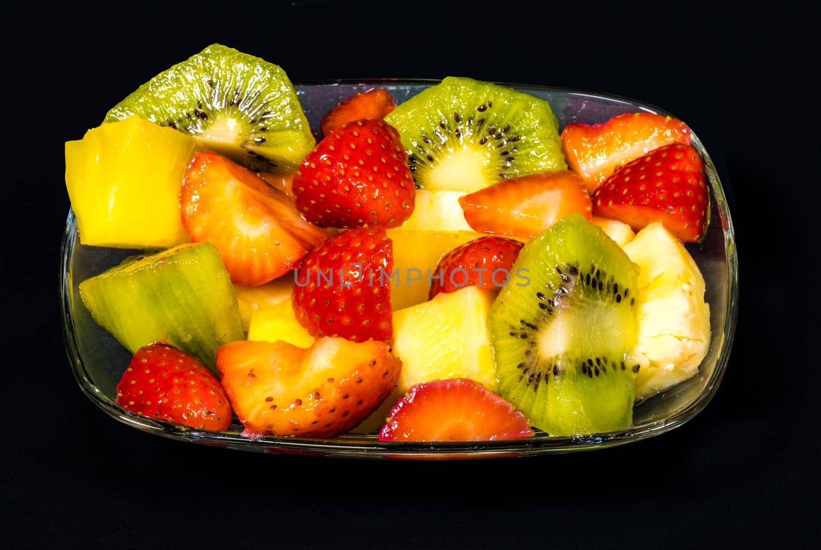 fresh fruit macedonia cut into cubes, Isolated background in black