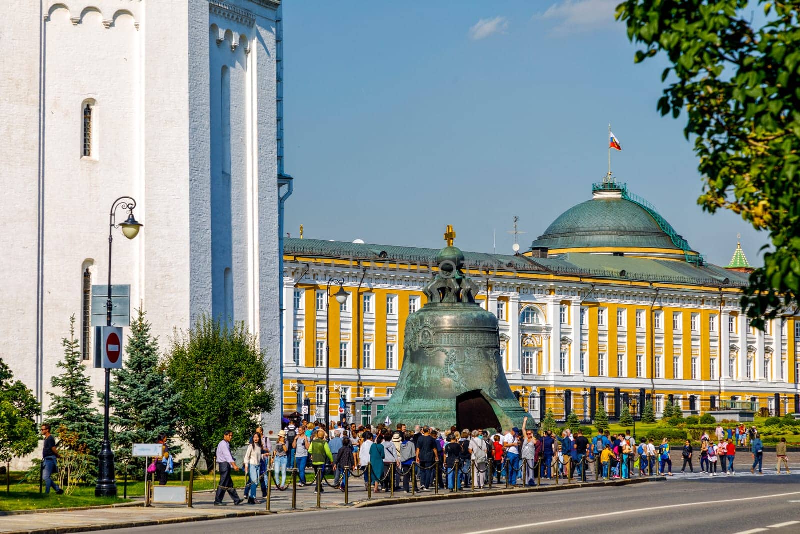 Moscow, Russia - September 15, 2018: Tourists visiting the Kremlin. Inside there is a giant bell in front of a cathedral