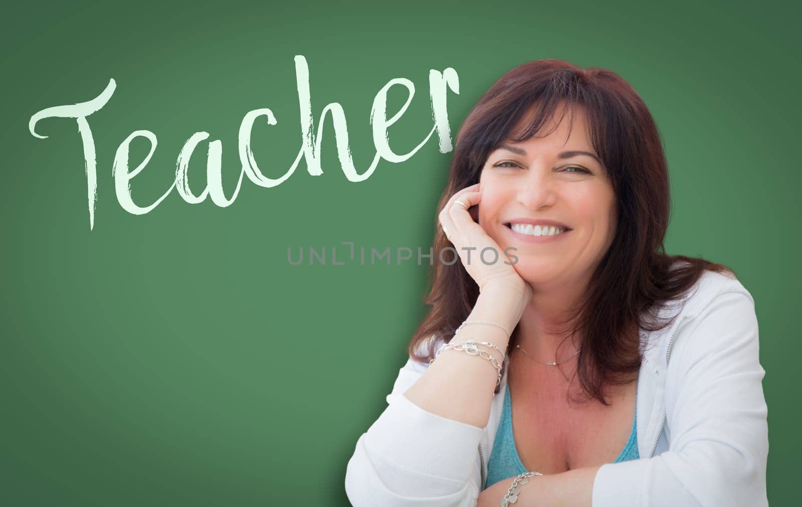 Teacher Written On Green Chalkboard Behind Smiling Middle Aged Woman.