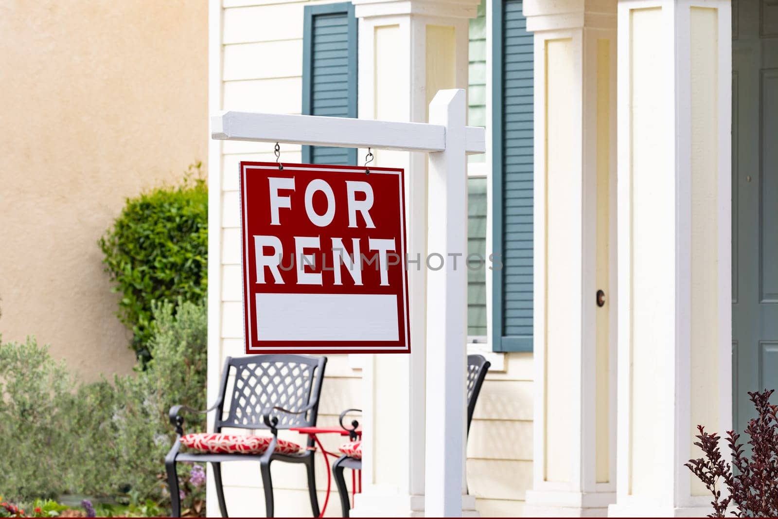 Red For Rent Real Estate Sign in Front House.