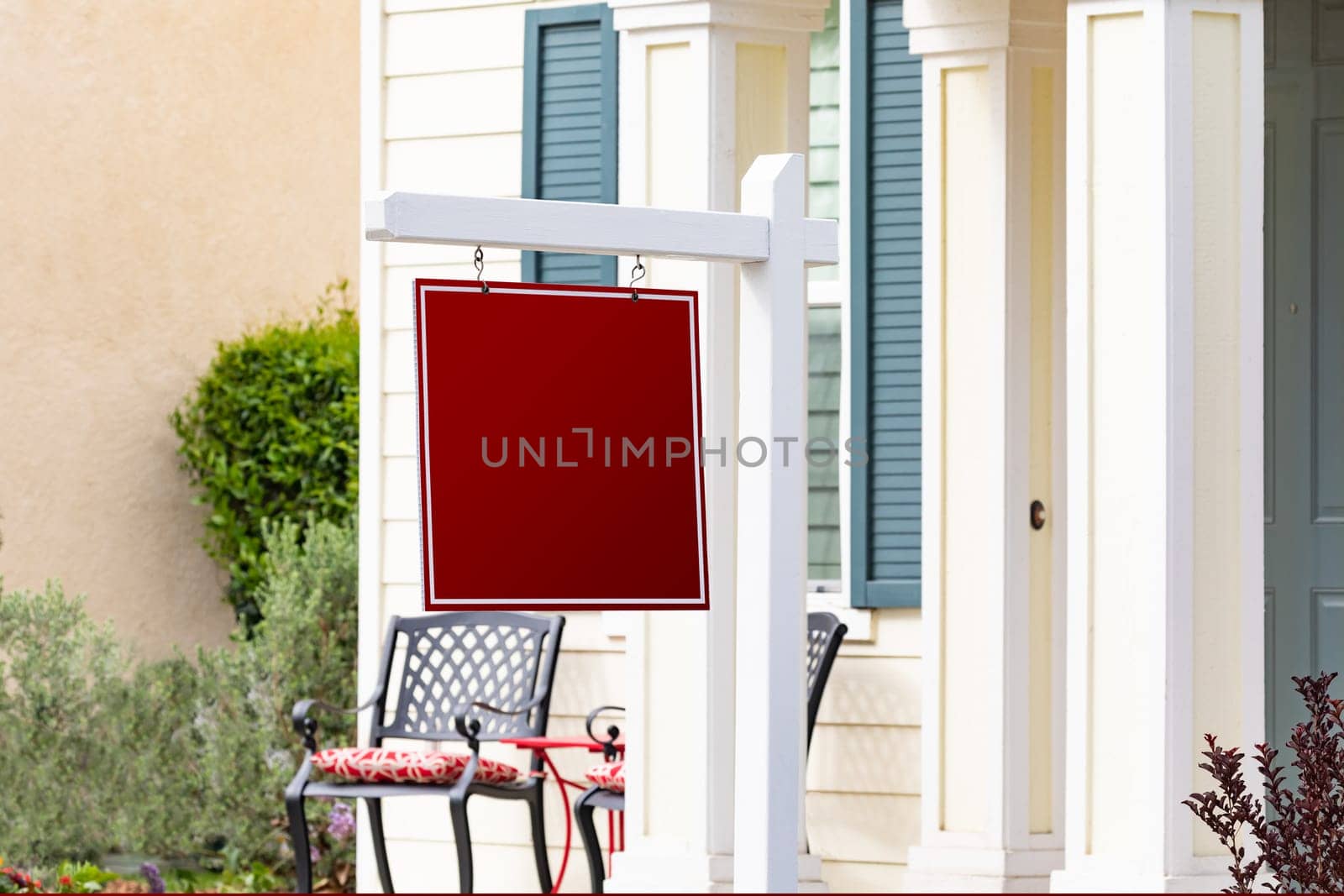 Blank Sale Real Estate Sign in Front of House.