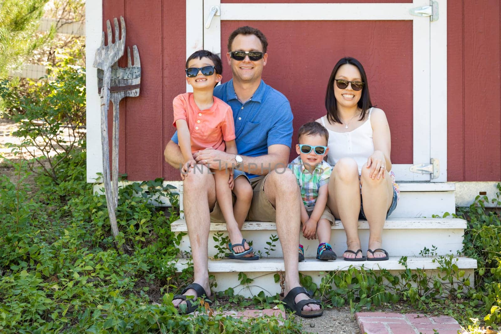 Portrait of Caucasian and Chinese Couple with Their Mixed Race Young Boys Wearing Sunglasses