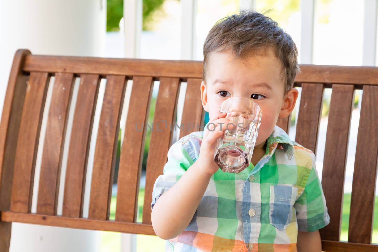 Mixed Race Chinese and Caucasian Boy Enjoying A Glass Of Water