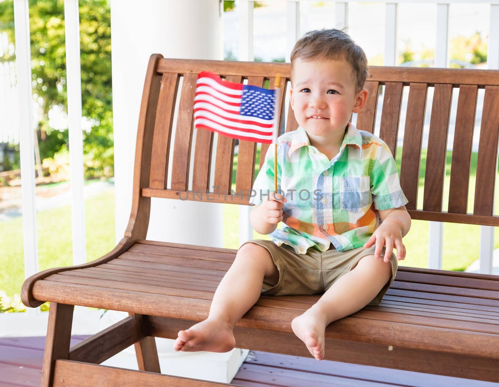 Young Mixed Race Chinese and Caucasian Boy Playing With American Flag