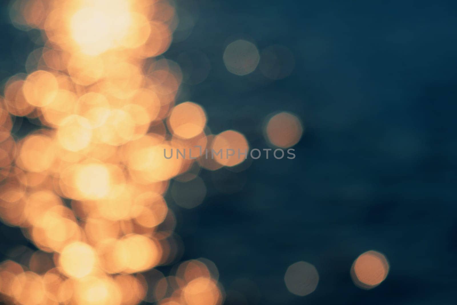Golden sunlights on blue water background.