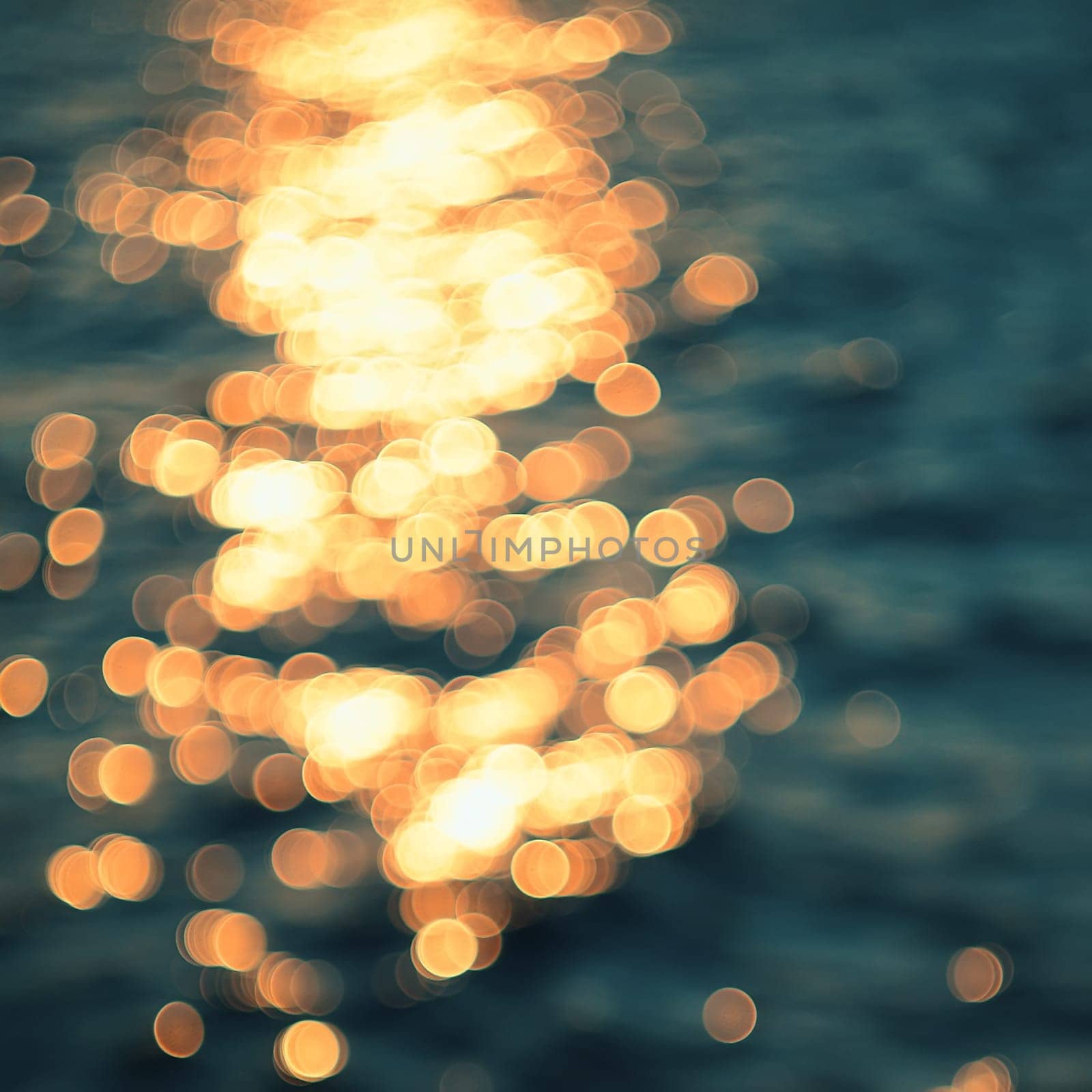 Golden sunlights on blue water background.