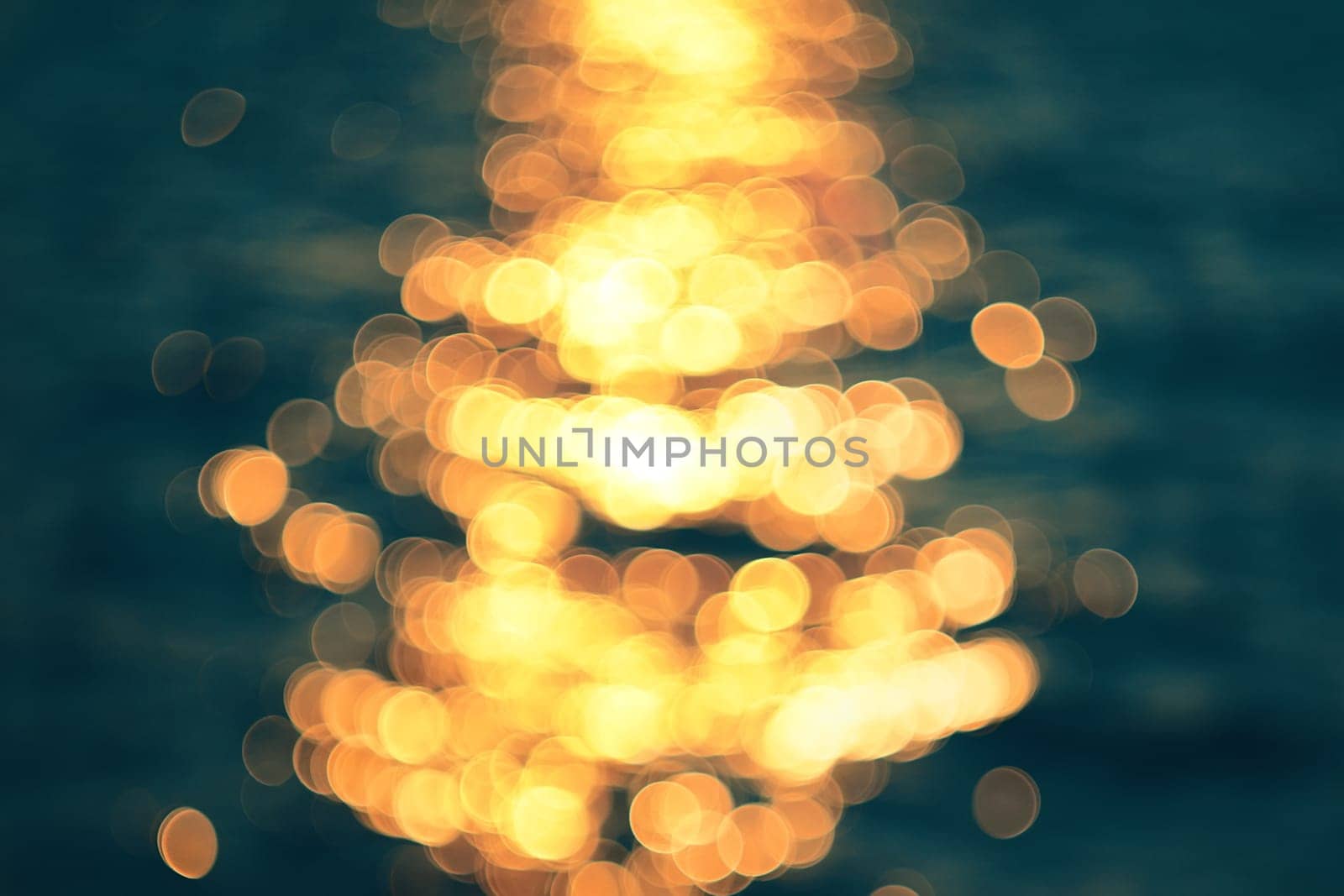 Golden sunlights on blue water background.
