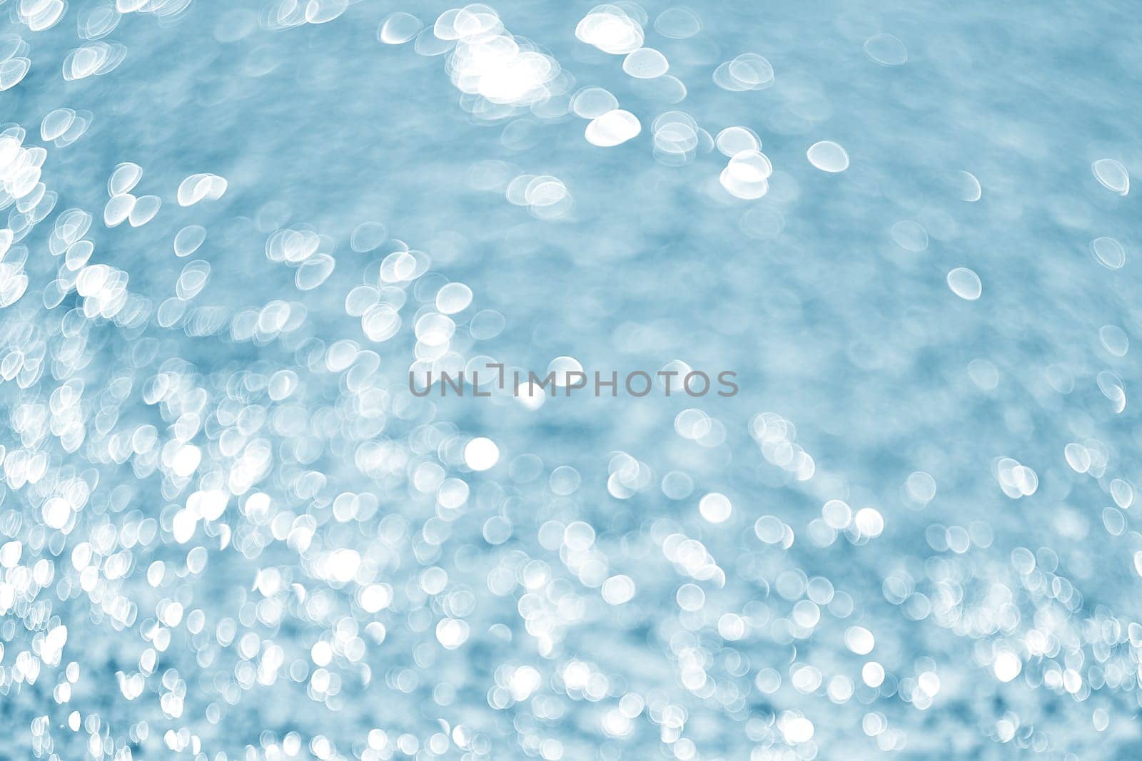 Sea and stones background.Lights on blue background.Underwater.