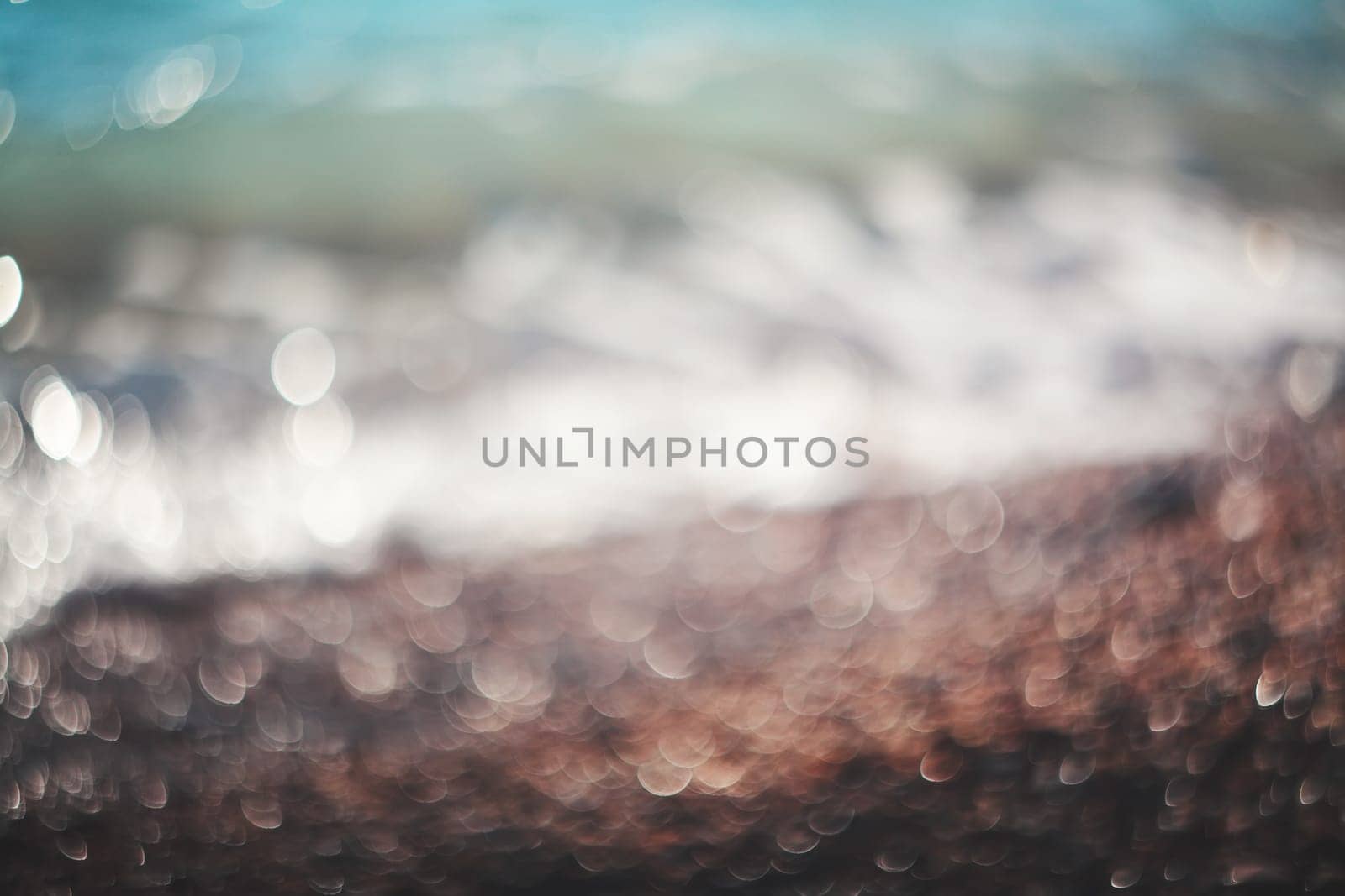 Water bokeh lights on the coastline.Natural background.
