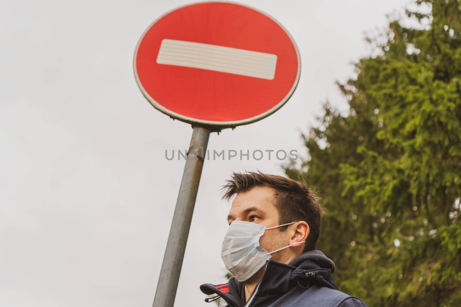 Man wearing facial hygienic mask. Ecology, air pollution car, Environmental and virus protection concept. Mask covered with toxic dust.