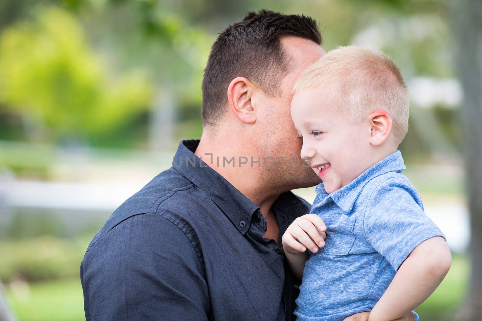 Young Caucasian Father and Son Having Fun At The Park.