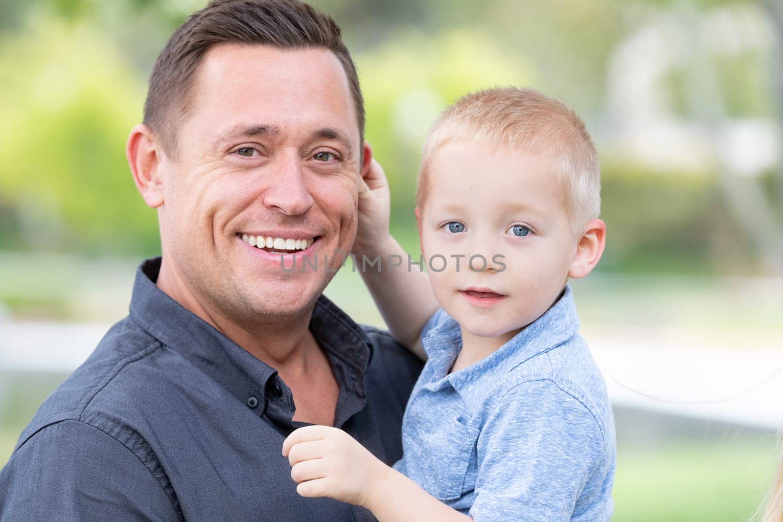 Young Caucasian Father and Son Having Fun At The Park.