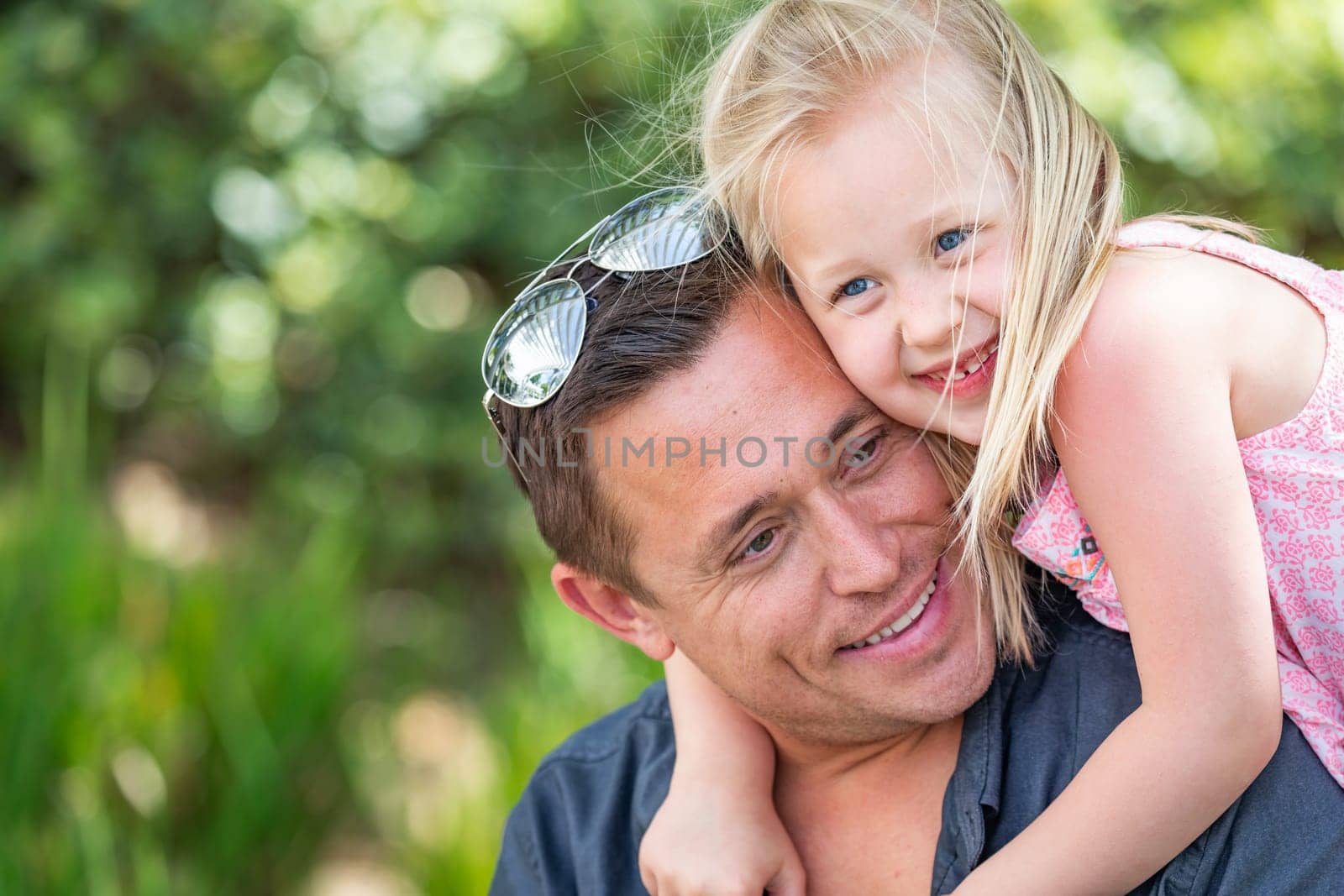 Young Caucasian Father and Daughter Having Fun At The Park.