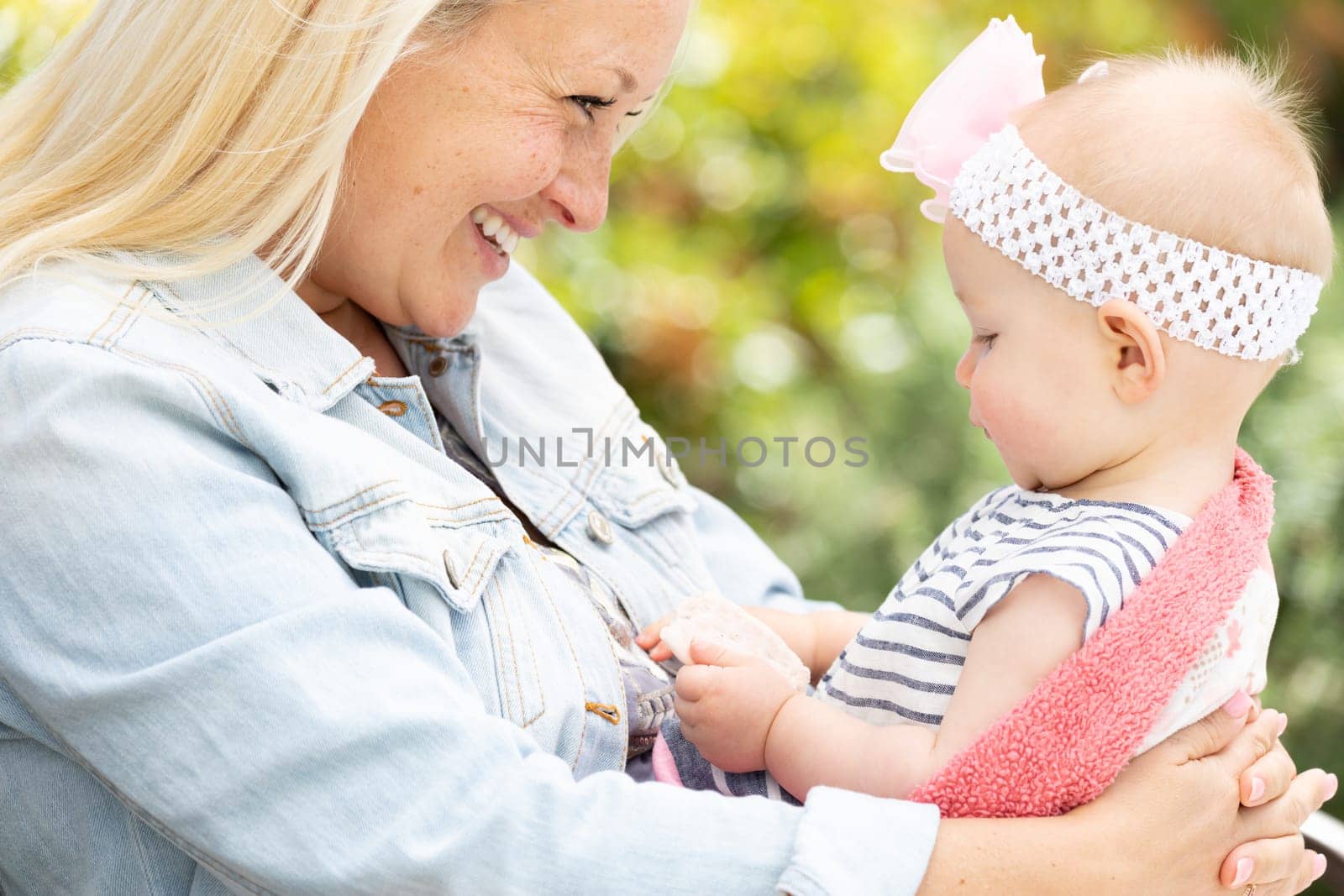 Young Caucasian Mother and Daughter At The Park.