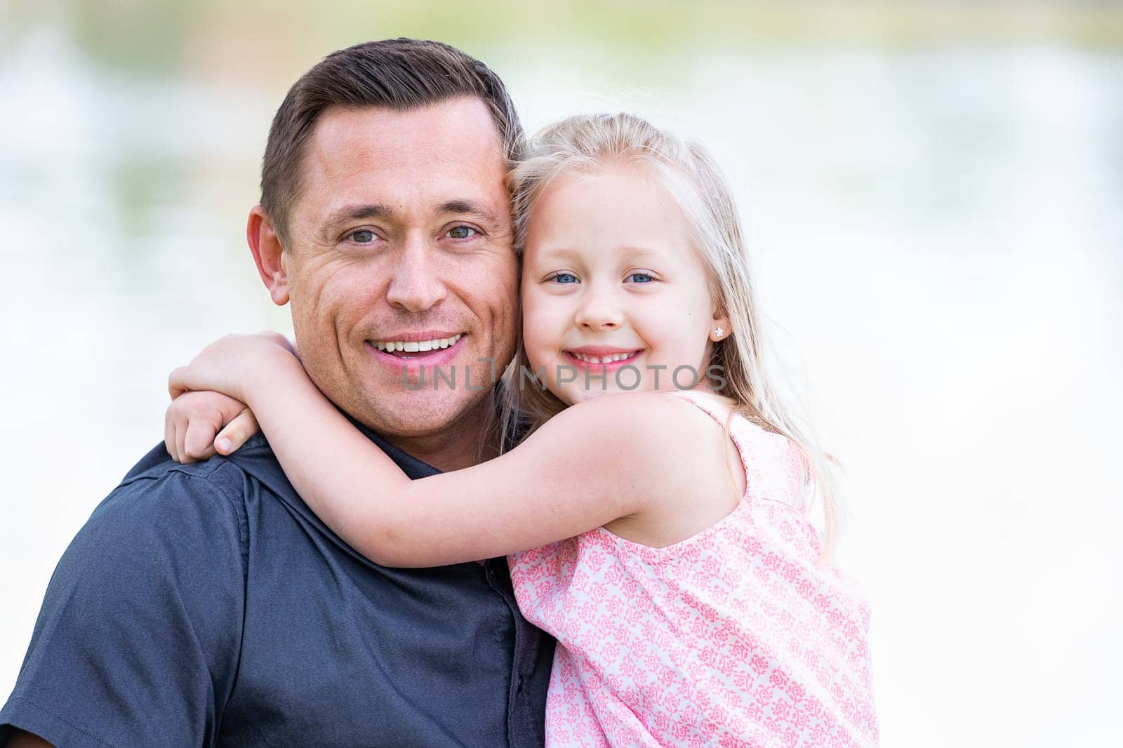 Young Caucasian Father and Daughter Having Fun At The Park.