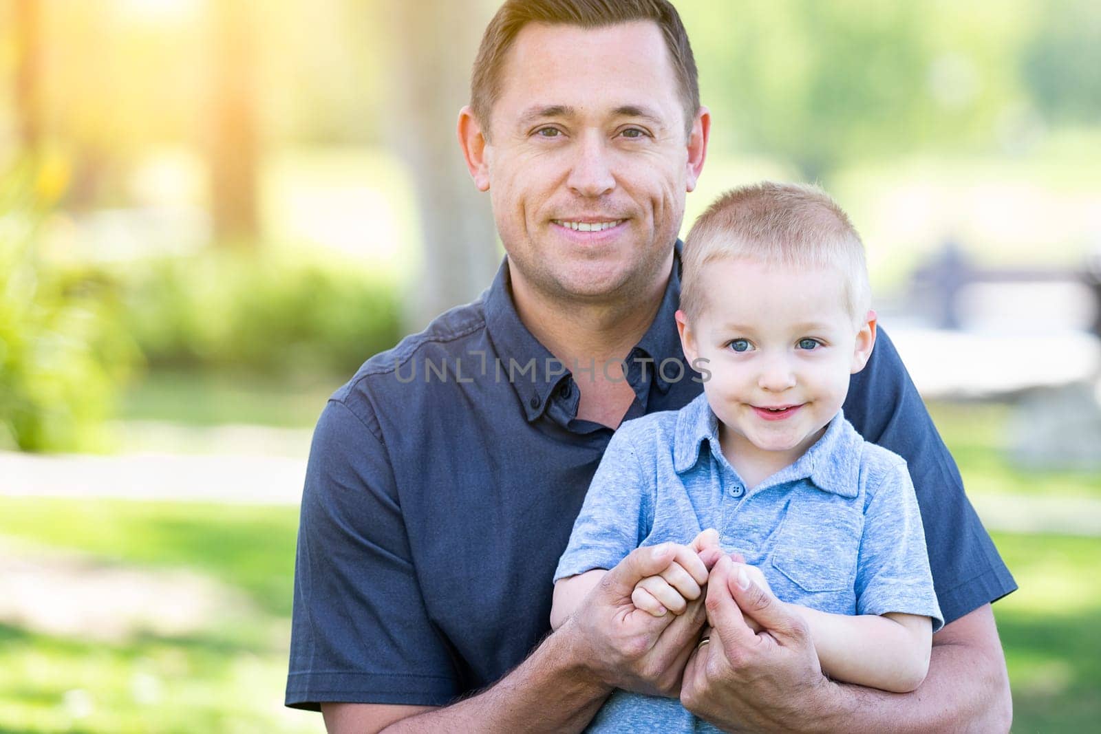 Young Caucasian Father and Son Having Fun At The Park.