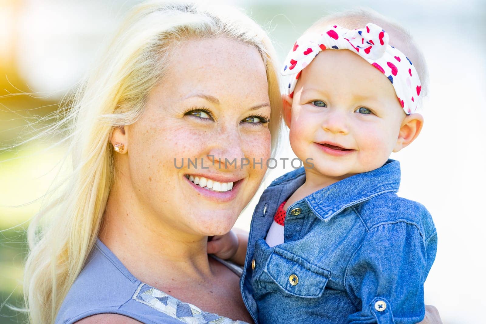 Young Caucasian Mother and Daughter At The Park.