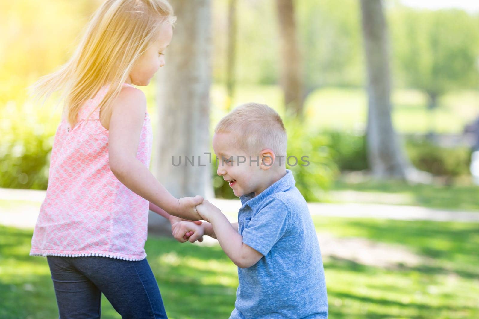 Young Brother and Sister Playing At The Park Togther.