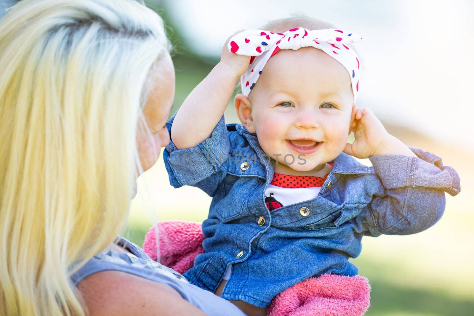 Young Caucasian Mother and Daughter At The Park.