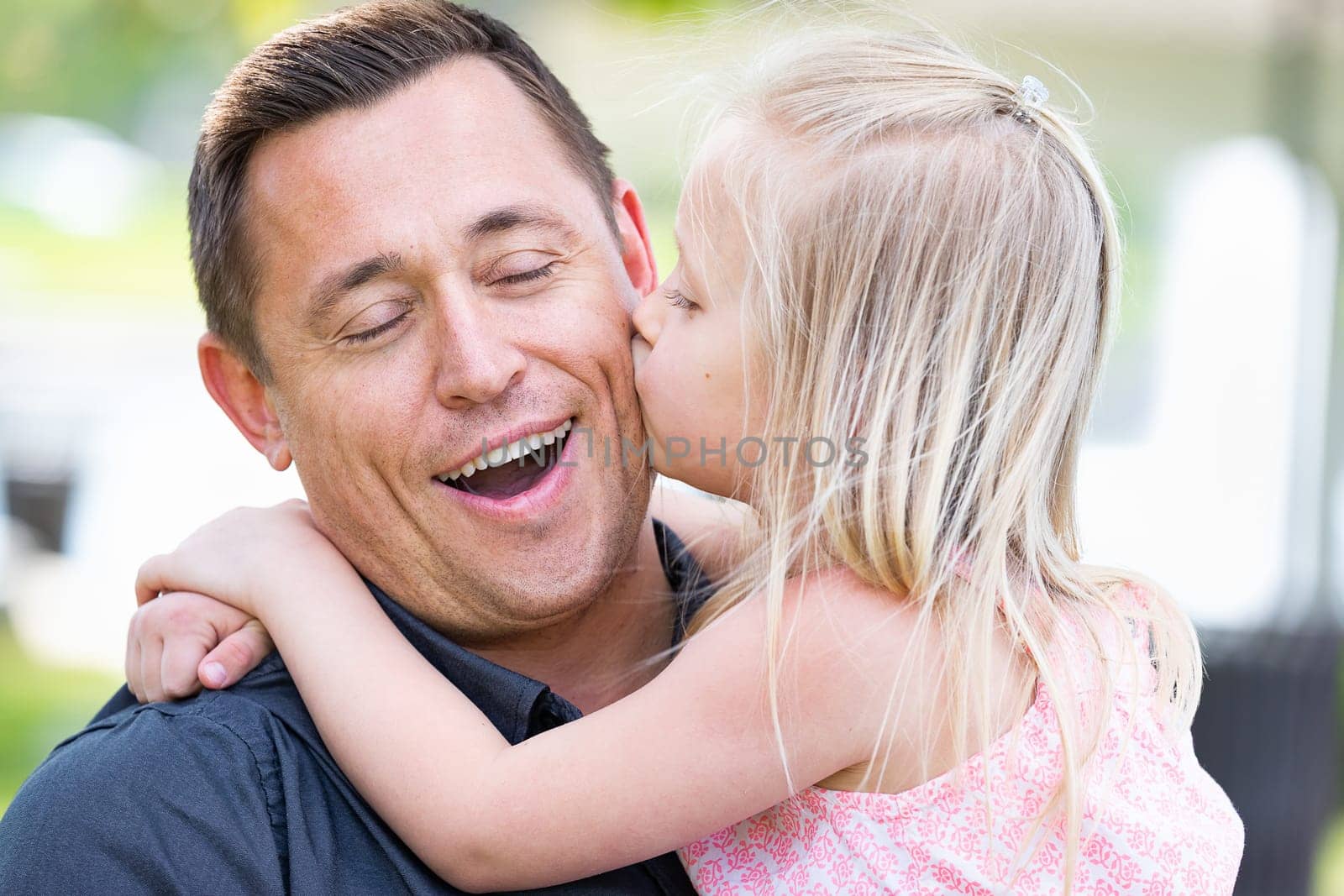 Young Caucasian Father and Daughter Having Fun At The Park.