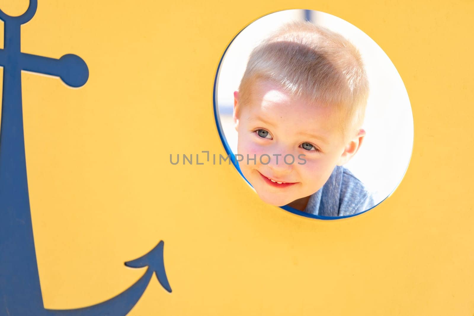 Happy Young Boy Having Fun At The Playground.