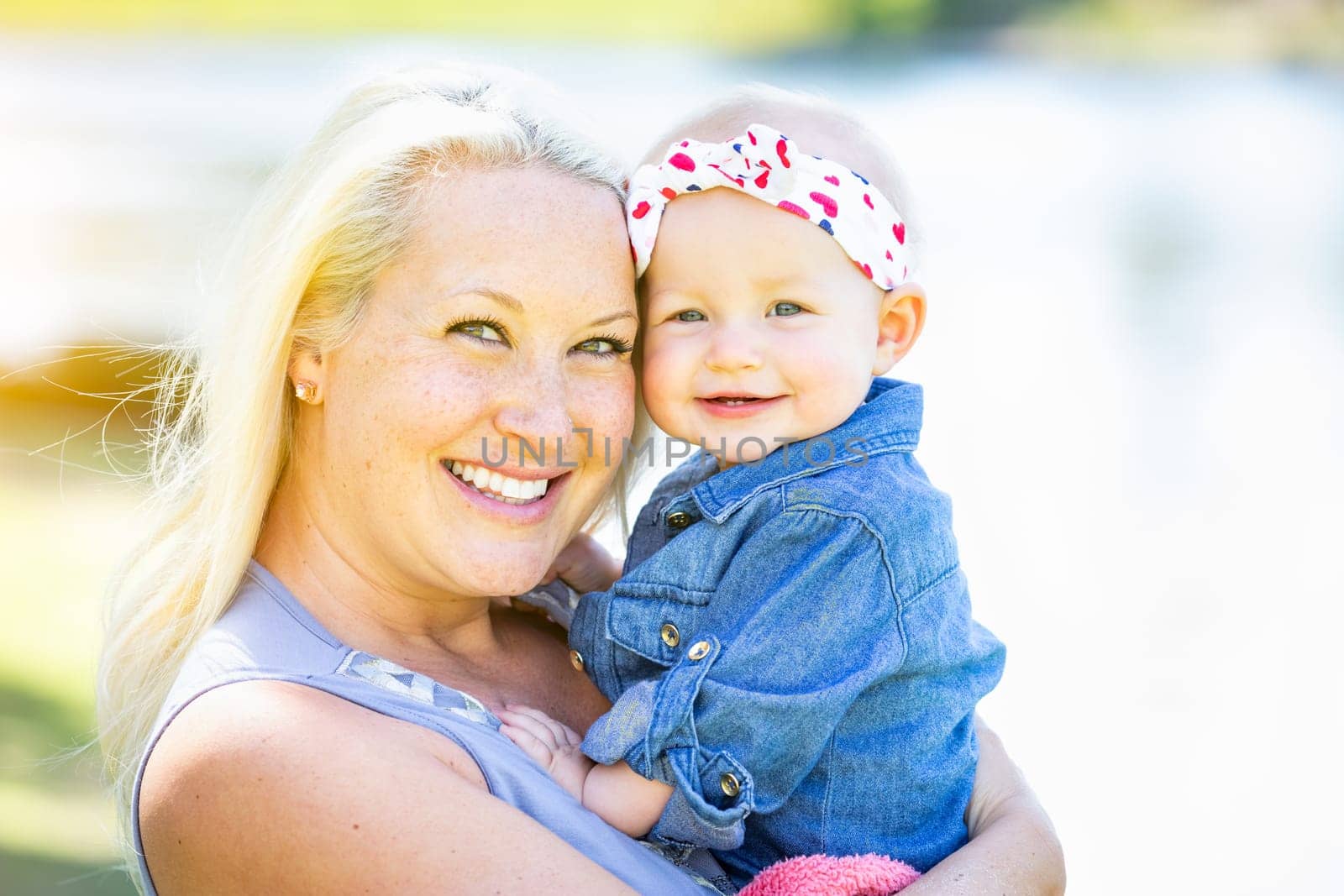 Young Caucasian Mother and Daughter At The Park.