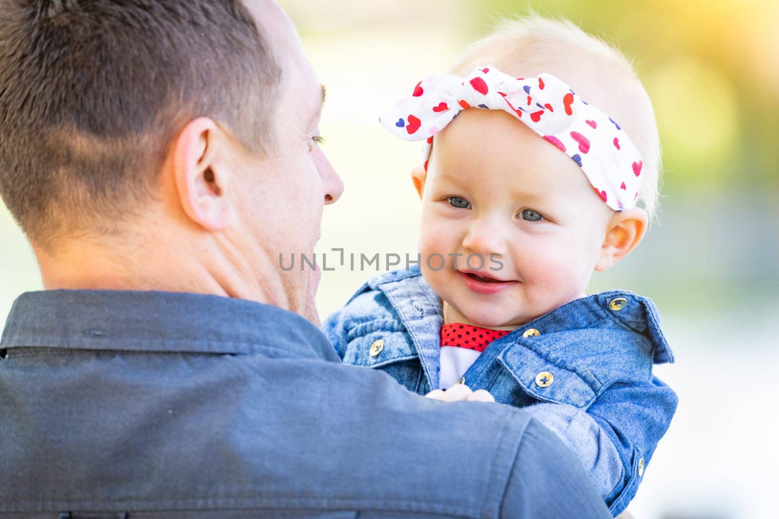 Young Caucasian Father and Baby Girl At The Park.