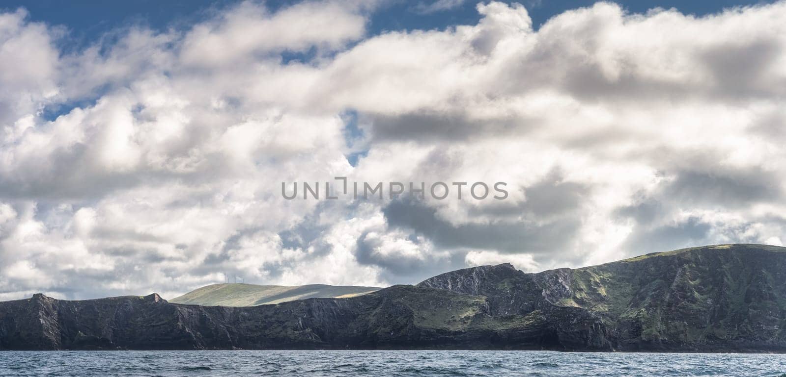Panorama with beautiful, rough Irish coastline, Kerry Cliffs, seen from boat on Atlantic Ocean, Portmagee, Iveragh Peninsula, Ring of Kerry, Ireland