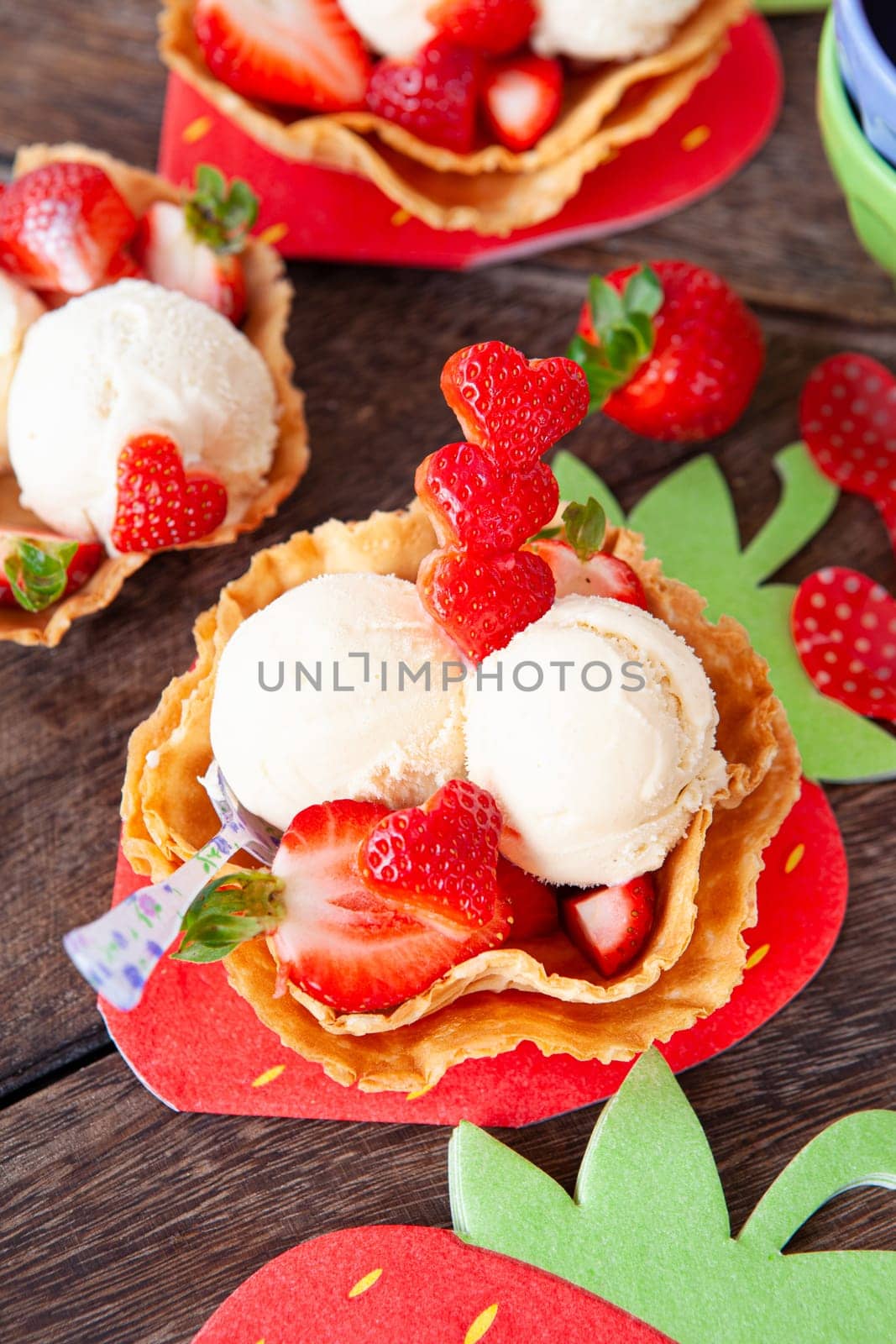 Vanilla ice cream with fresh strawberries in waffle cups