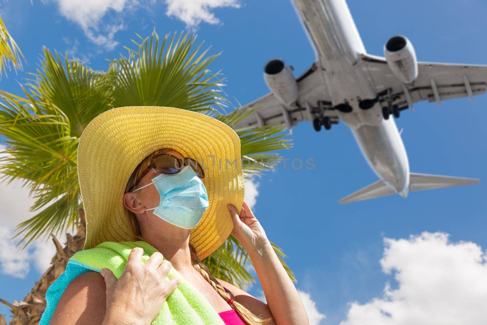 Girl With Towel, Hat, Sunglasses and Face Mask Under Palm Tree and Airplane..