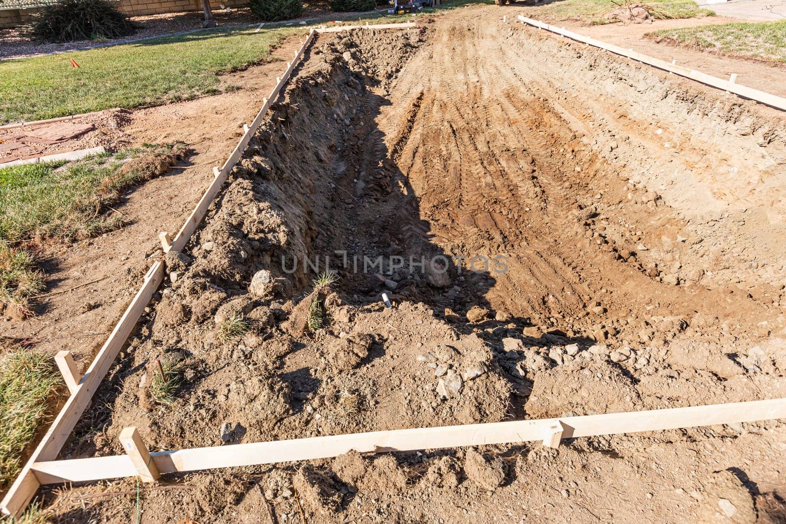 Freshly Dug Hole In Yard Preparing For Swimming Pool Installation.
