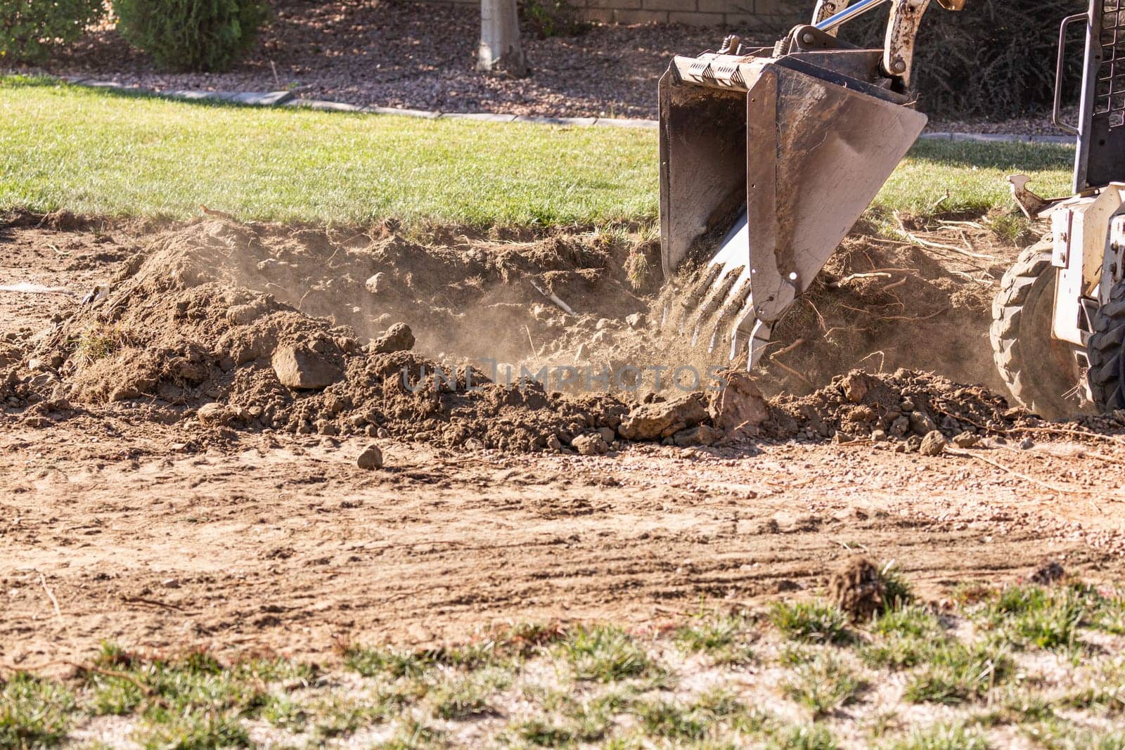 Small Bulldozer Digging In Yard For Pool Installation.
