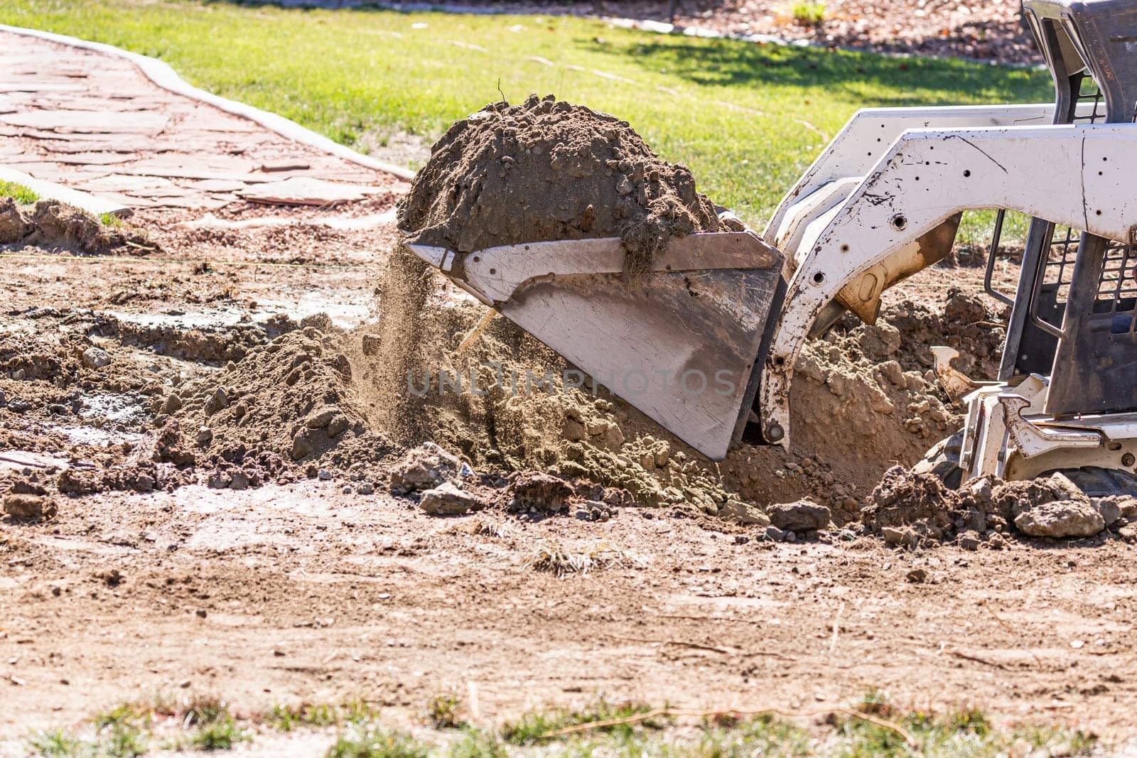 Small Bulldozer Digging In Yard For Pool Installation.