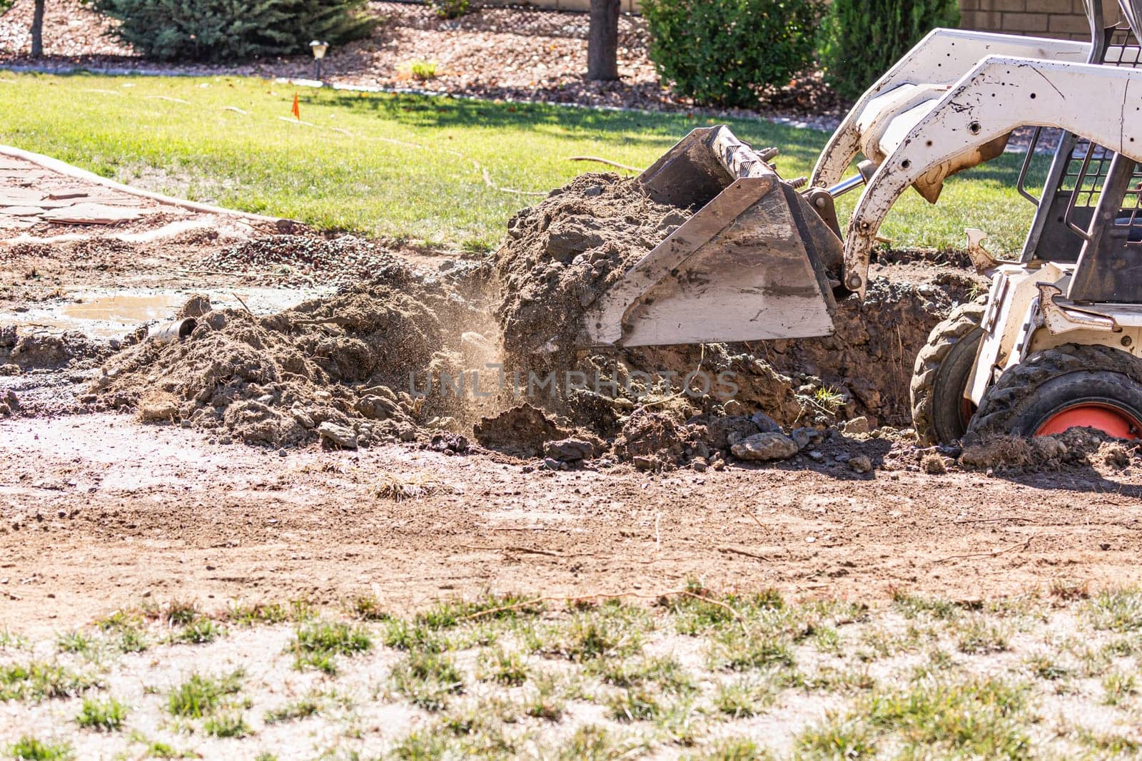 Small Bulldozer Digging In Yard For Pool Installation.