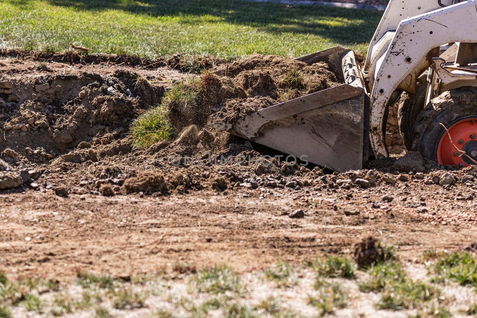 Small Bulldozer Digging In Yard For Pool Installation.
