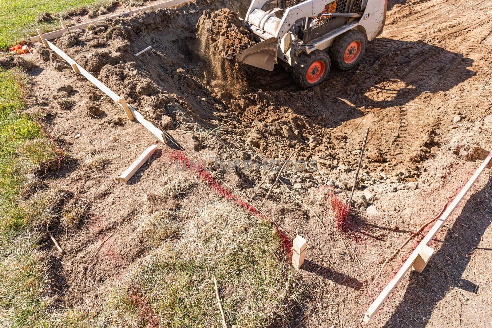 Small Bulldozer Digging In Yard For Pool Installation.