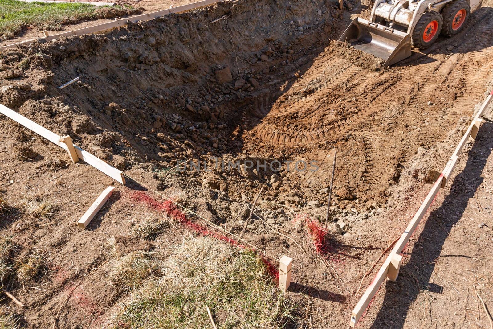 Small Bulldozer Digging In Yard For Pool Installation.