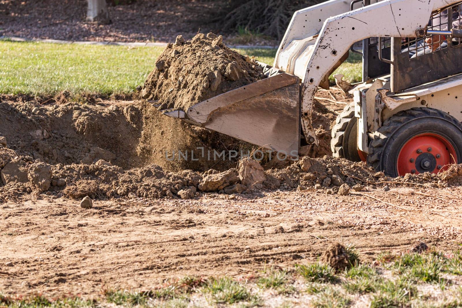 Small Bulldozer Digging In Yard For Pool Installation.