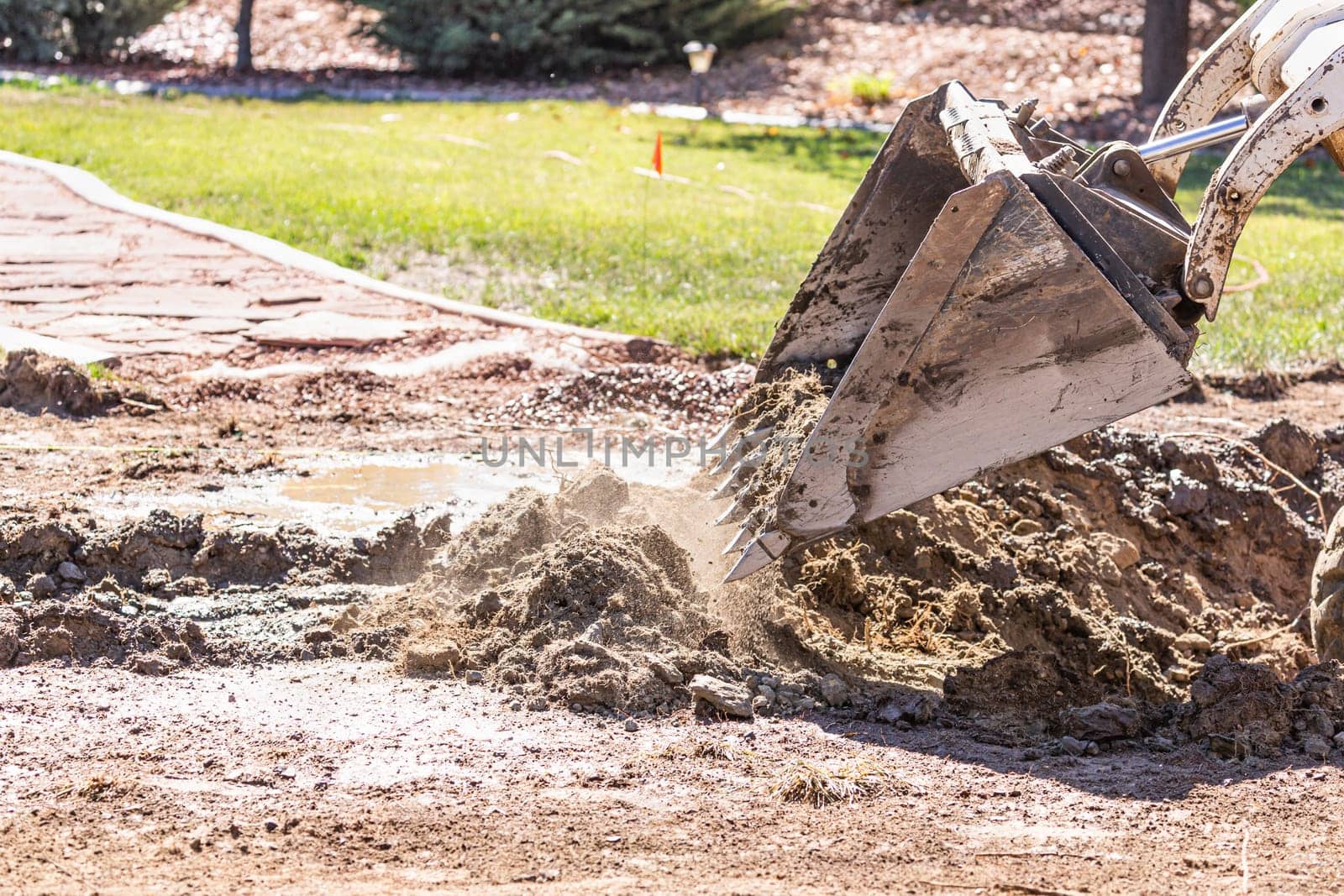 Small Bulldozer Digging In Yard For Pool Installation.