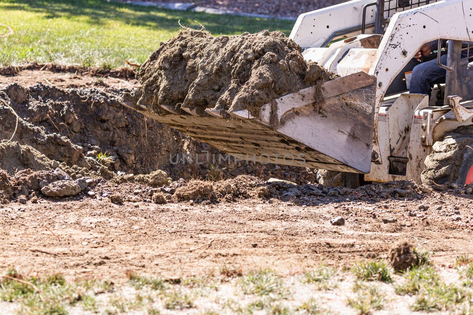 Small Bulldozer Digging In Yard For Pool Installation.