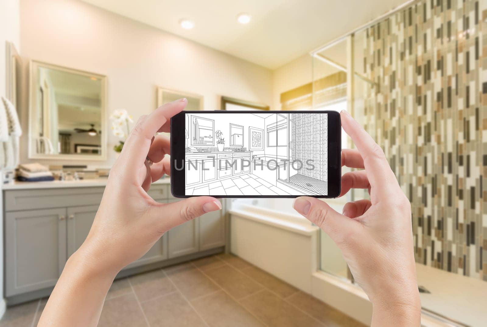 Hands Holding Smart Phone with Master Bathroom Drawing on Screen and Photo Behind.