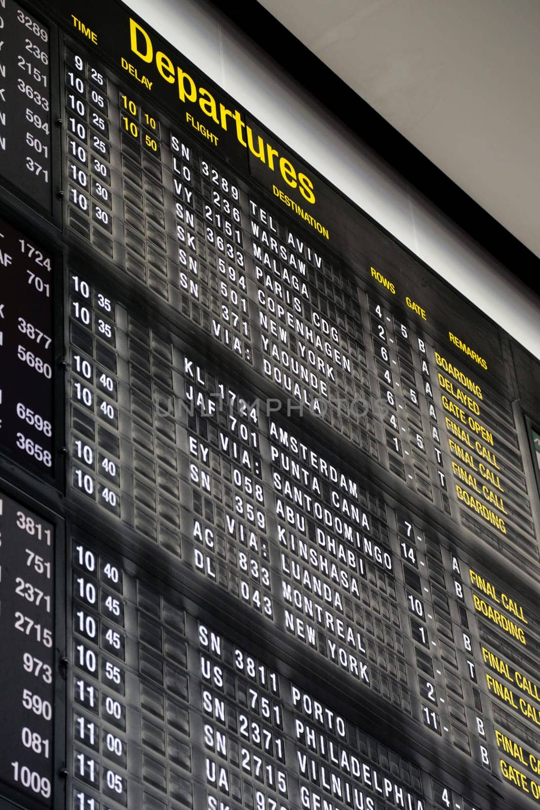 Airport departure board in terminal with flight information