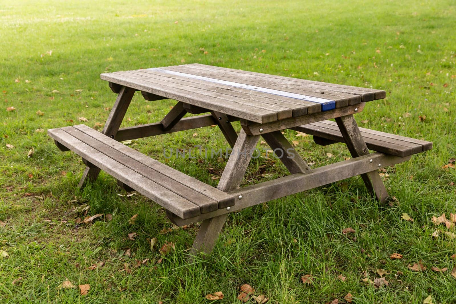 Outdoor bench with wooden table on a green meadow