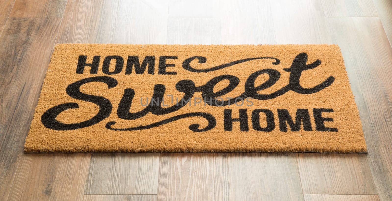 Home Sweet Home Welcome Mat On Wood Floor.