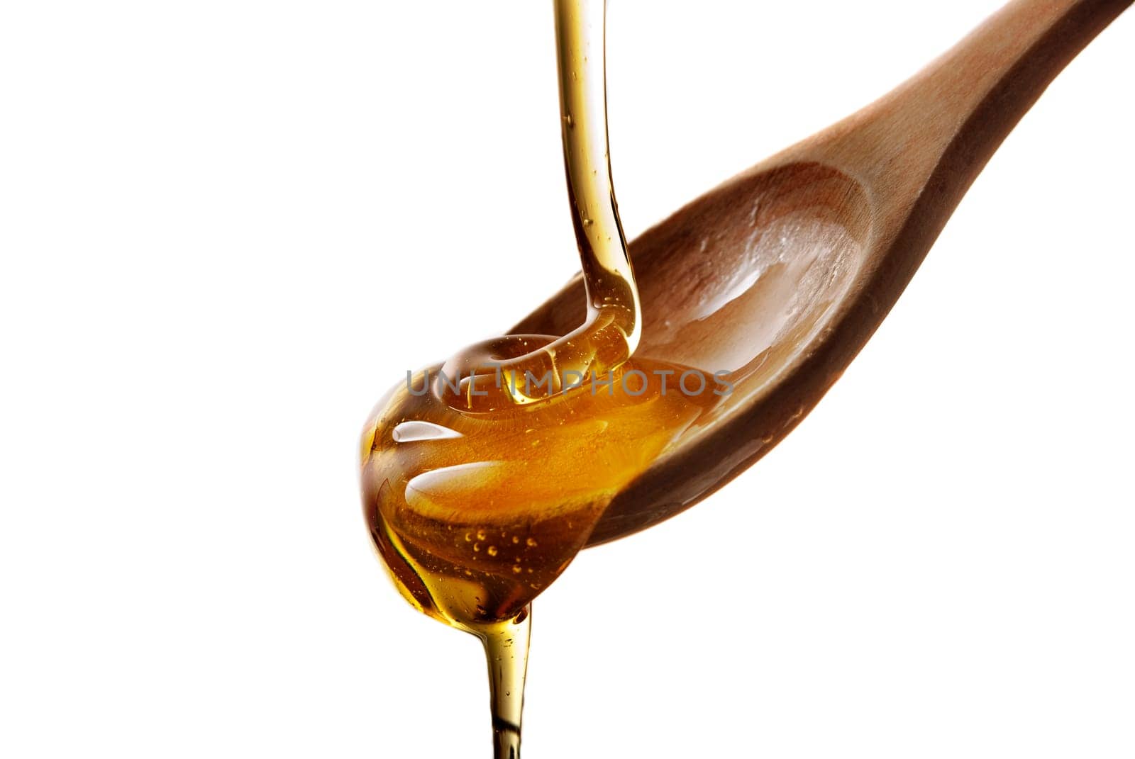 wooden spoon with honey isolated over white