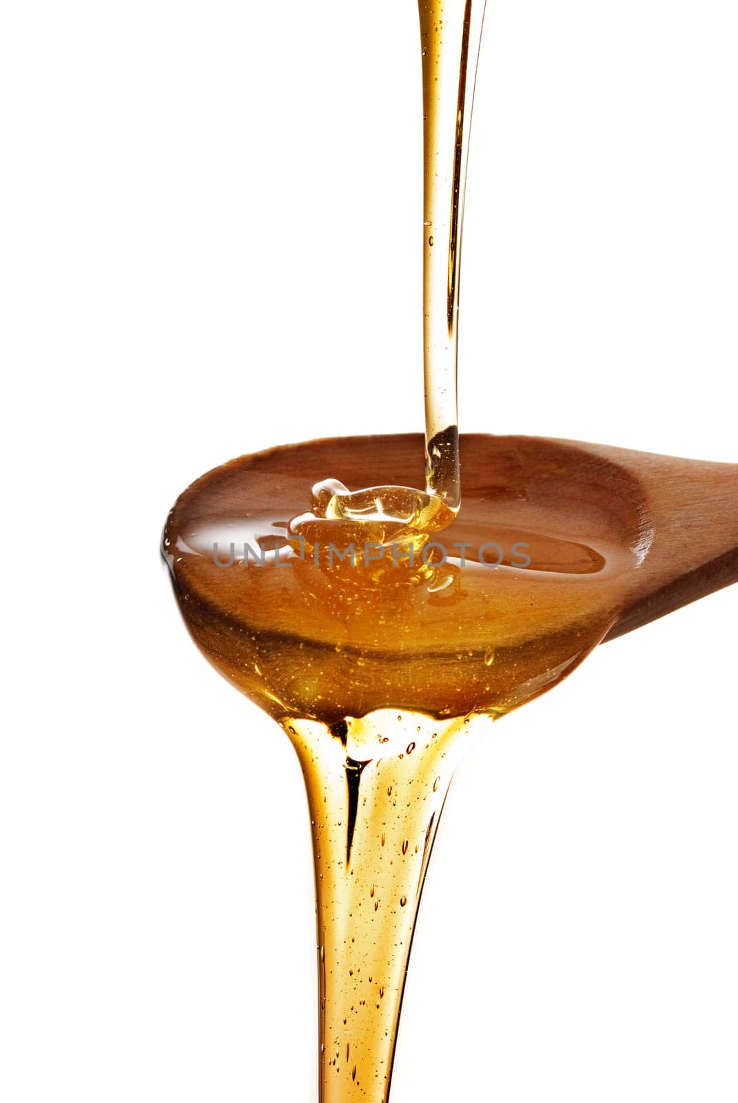 wooden spoon with honey isolated over white