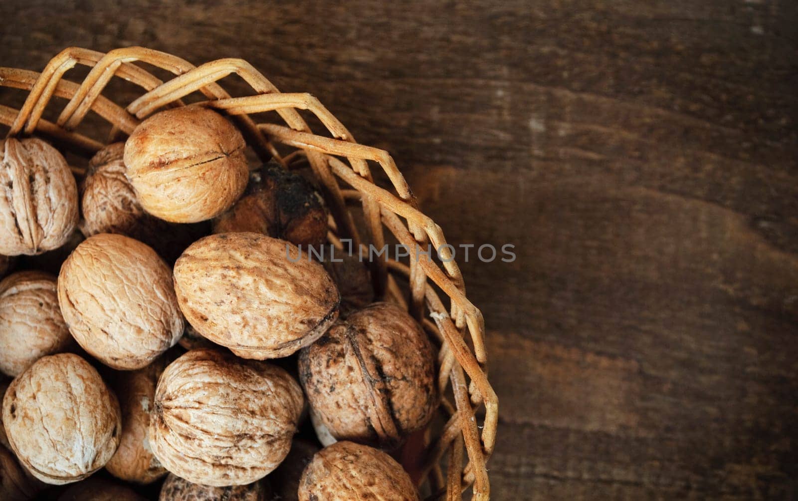 walnuts in the basket on wooden plank