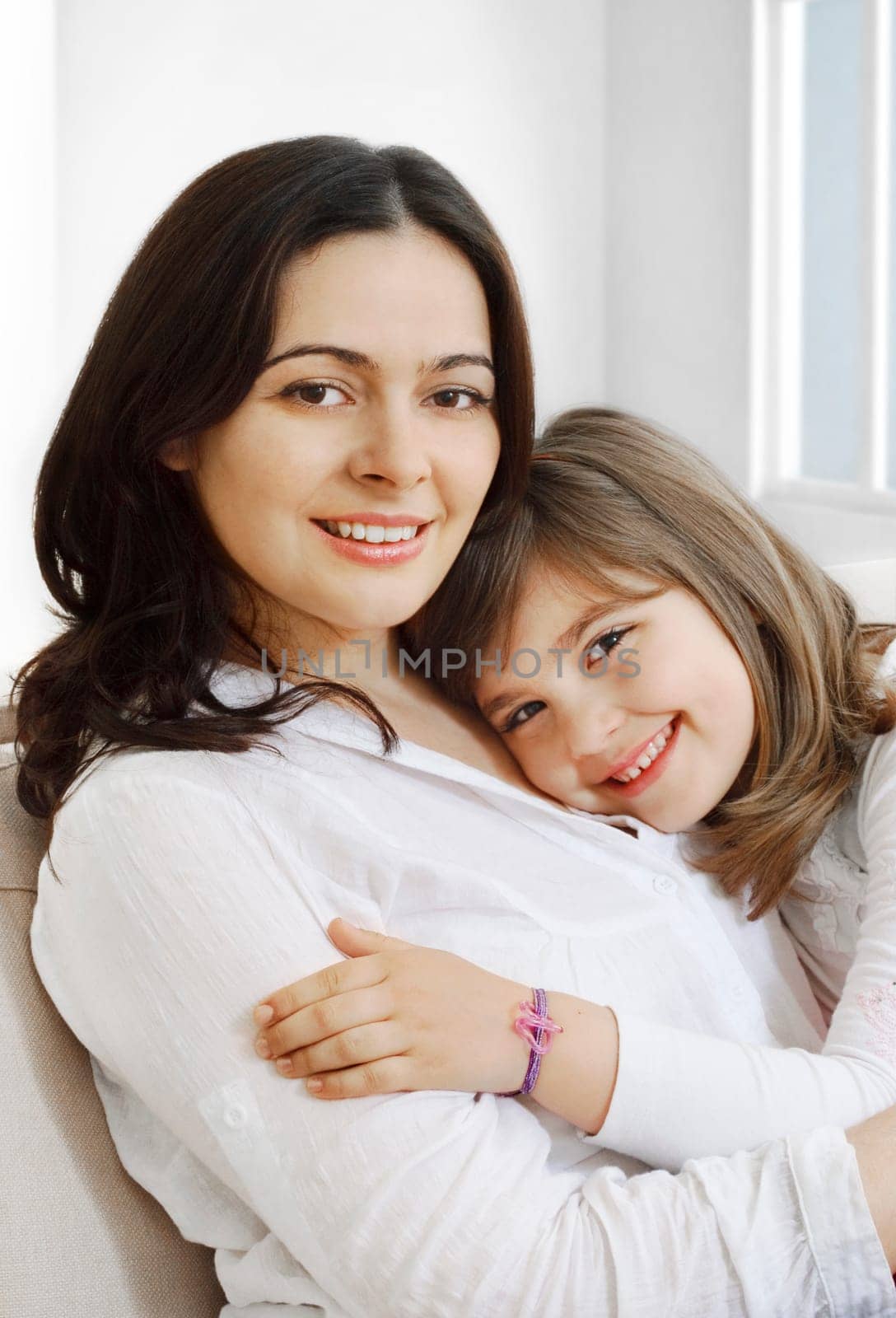 Portrait of happy mother and her smililing daugther